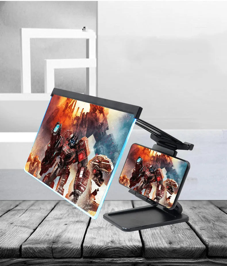 Black folding mobile phone screen magnifier with detachable phone holder on a desk.