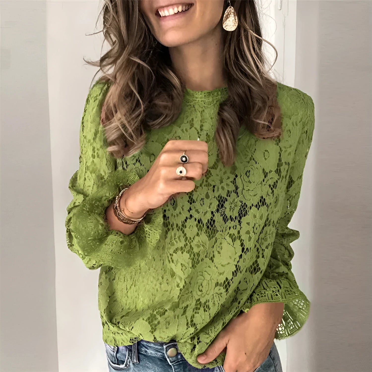 Women's green loose-fit lace shirt with hollow-out detailing and a zip, long sleeves, and a round neck.