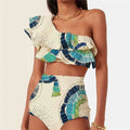 White women's swimsuit with one-shoulder design featuring large lotus leaf detailing and split hem
