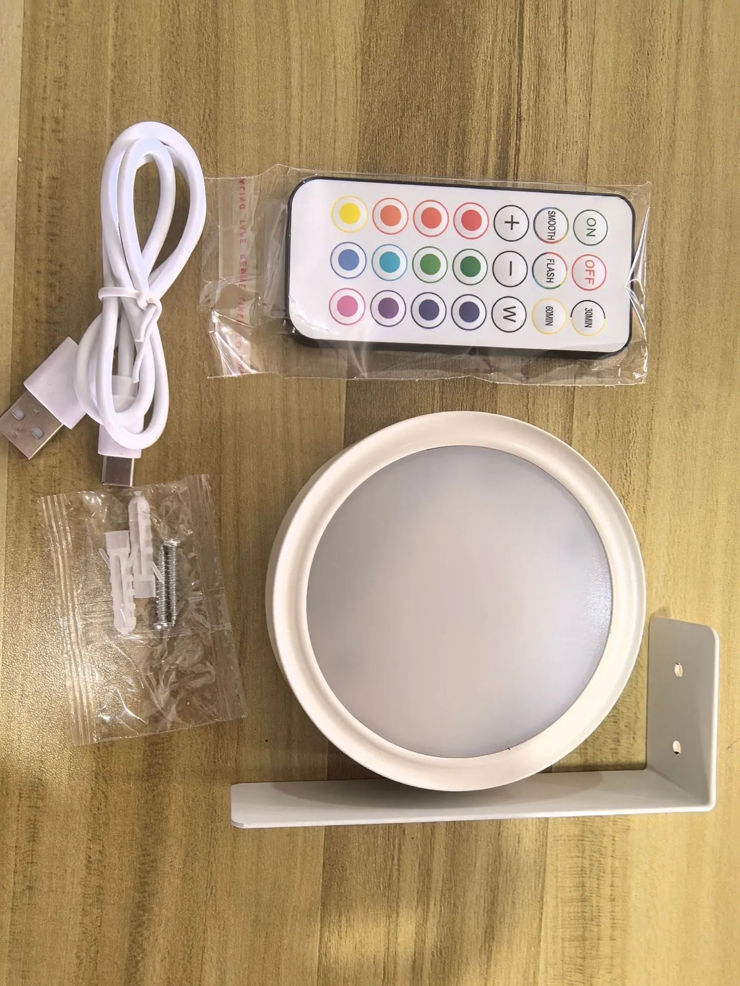 Wireless LED painting lamp with a magnetic mounting belt and remote control in black finish.