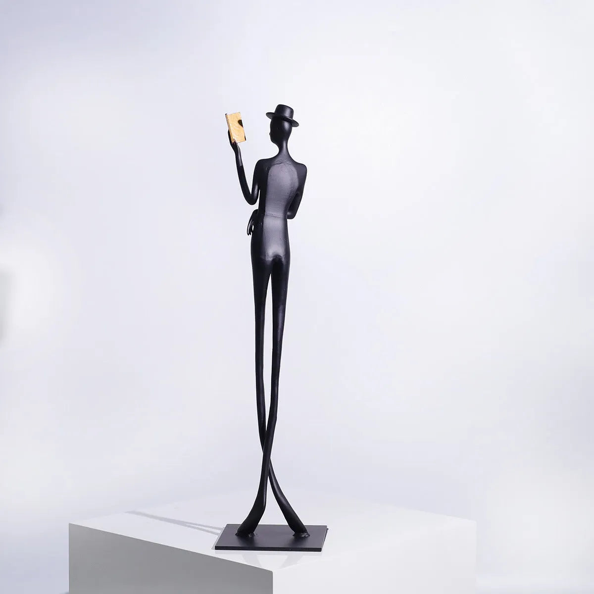 Black cast aluminum modern character desktop sculpture measuring 51cm tall.