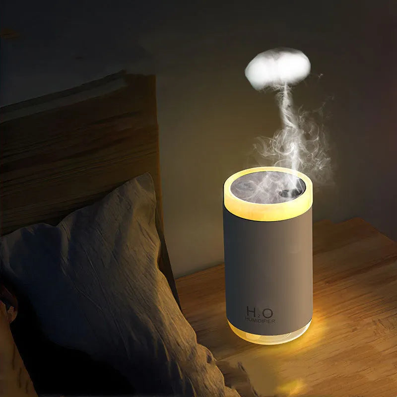 Jellyfish-shaped humidifier emitting smoke ring mist patterns with warm night light glow
