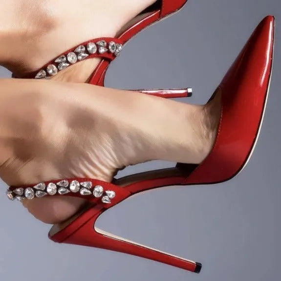 Women's patent leather high heel sandals with pointed toe, clear ankle strap, and rhinestone details.