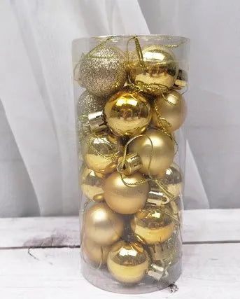 Assorted 3cm shiny gold, red, and silver Christmas ball ornaments spilling from a tall storage barrel.
