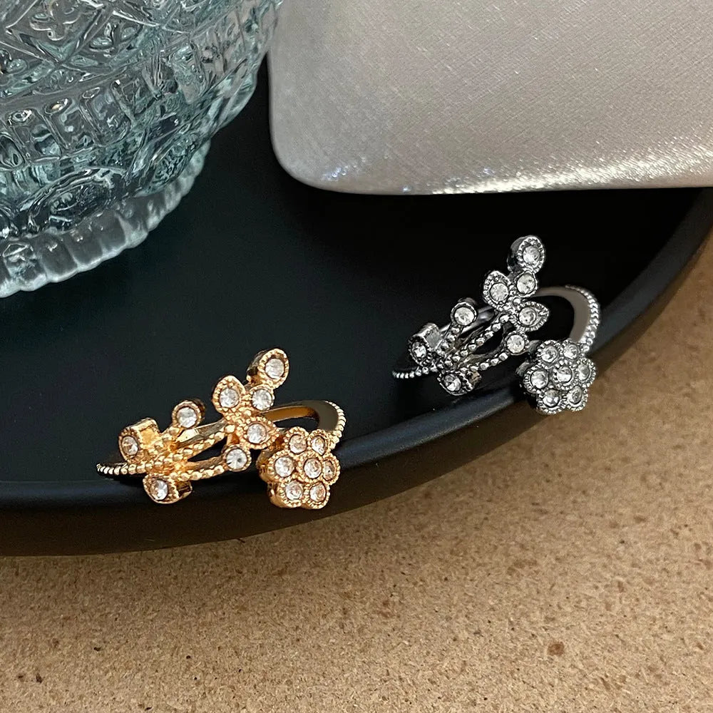 Copper open-ring with diamond-treated floral pattern and leaf details in gold colour