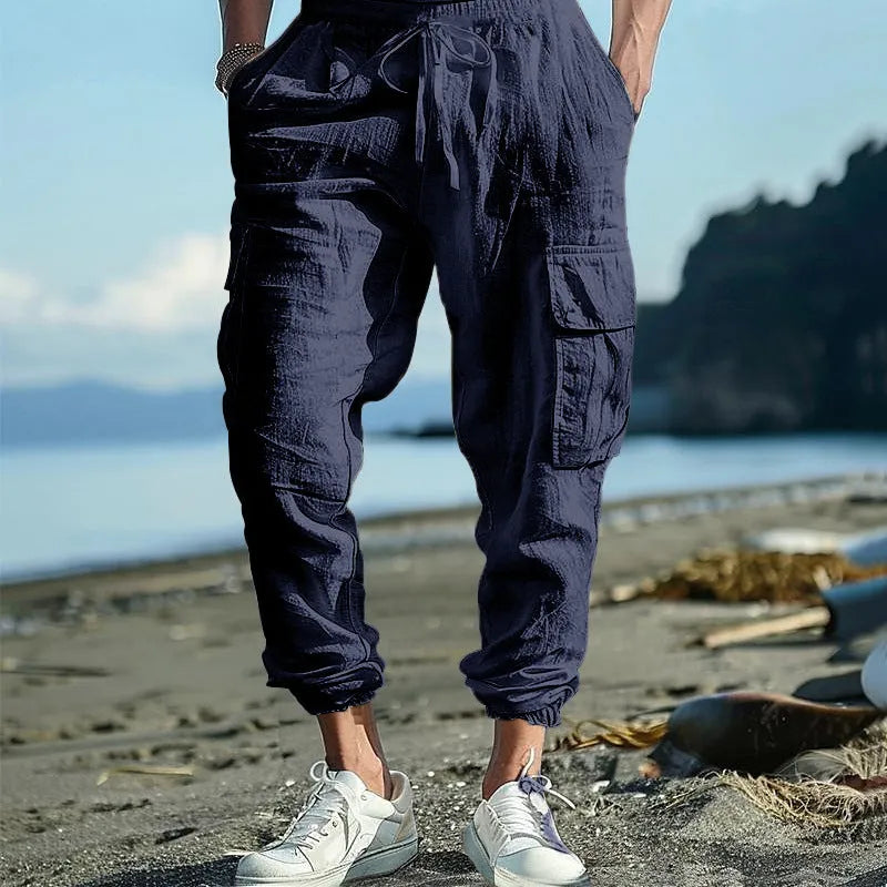 Men's loose-fit linen trousers in Army Green with ankle-tied cuffs and multiple pockets.