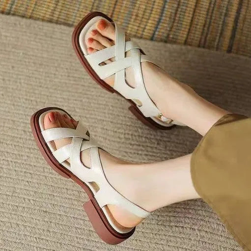 Women's glossy patent leather sandals with square toe and cross ankle strap in black, white, or brown.