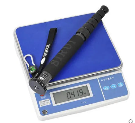 Black carbon fibre monopod for DSLR cameras extended to full height with camera mount visible