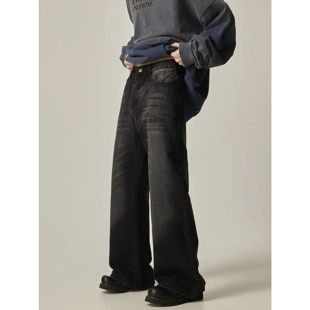 Black loose-fit straight-leg men's jeans with a zipper fly and retro styling.