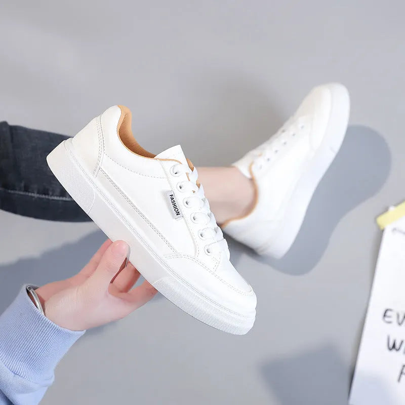 Korean style white low-top women's sneakers with a PU upper on a plain background.