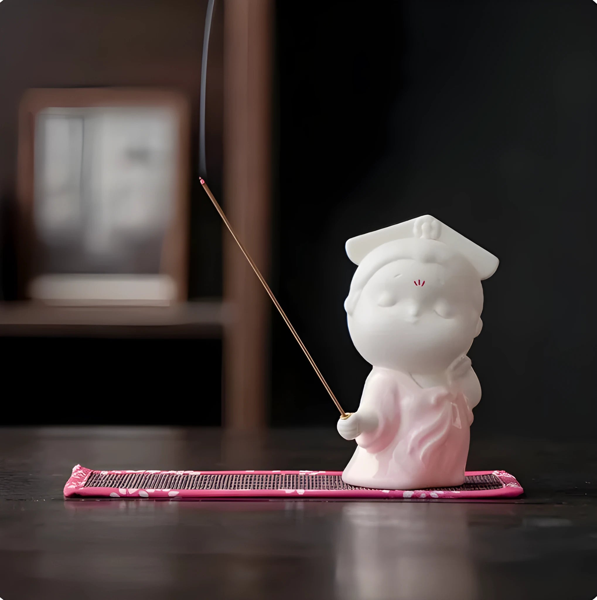 Ceramic cute female court attendant figurine incense burner decoration on a surface.