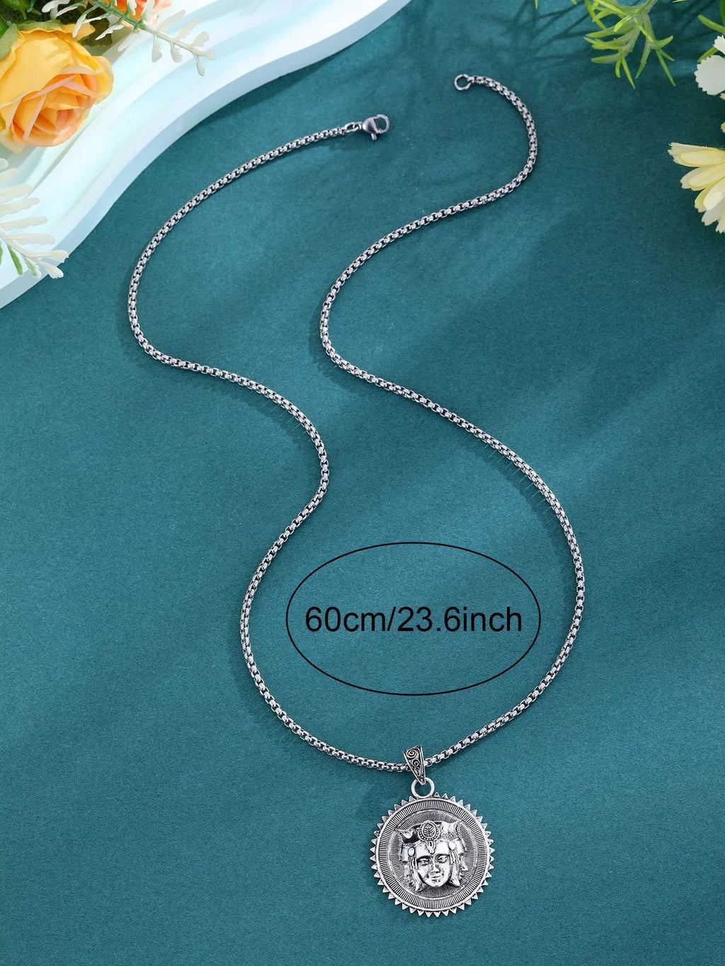 Head pendant sweater chain necklace for men in silver colour with heavy link chain on neutral background