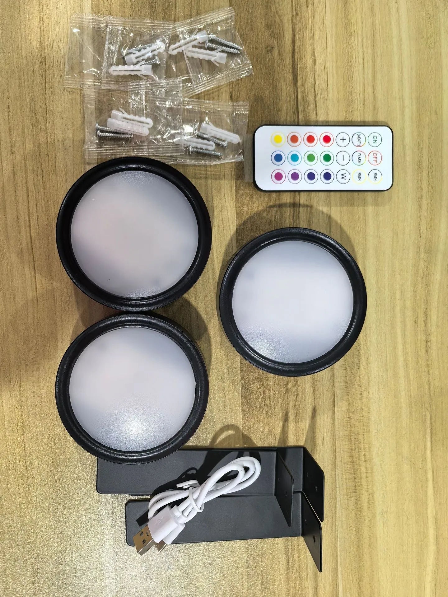 Wireless LED painting lamp with a magnetic mounting belt and remote control in black finish.