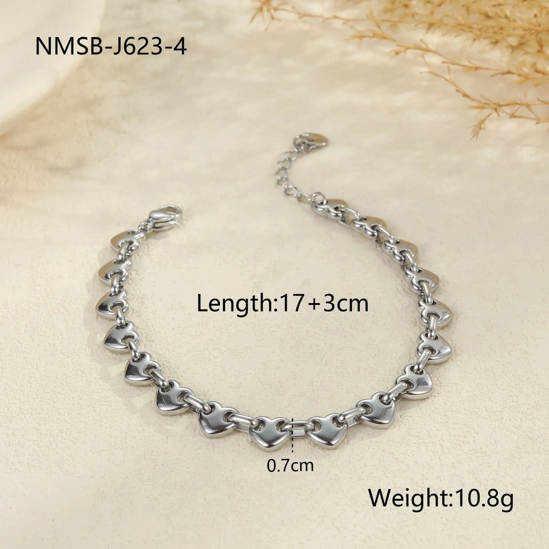 Stainless steel women's bracelet with a hollowed-out heart charm in gold or steel colour.