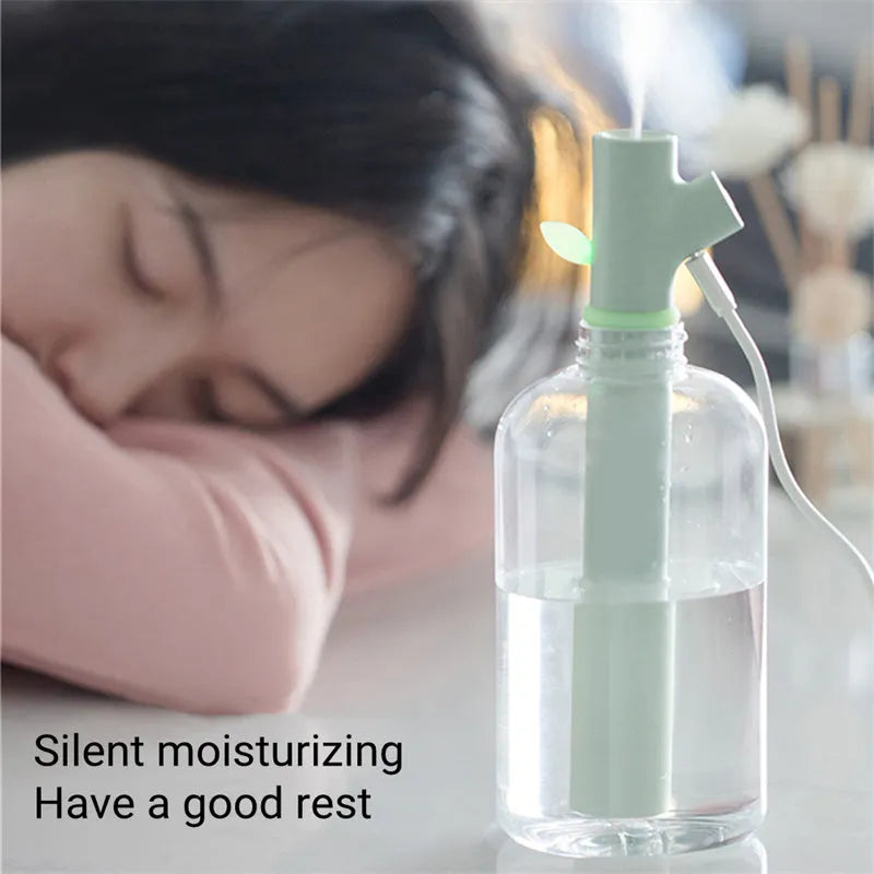Transparent plastic USB humidifier with branch design and water visible inside