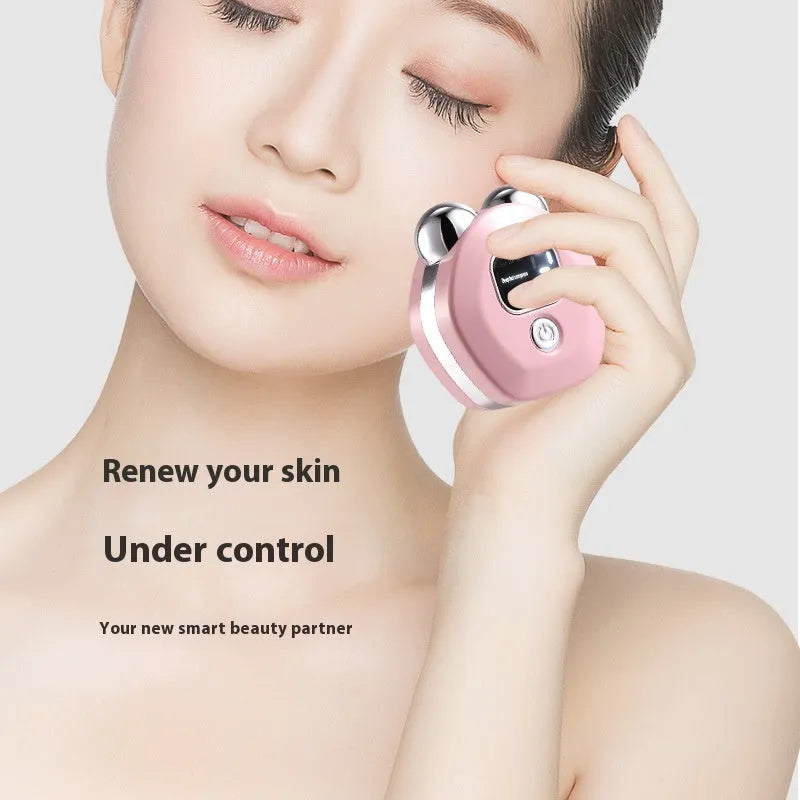 Portable white hot compress micro current facial massage instrument with double-roller head on a table.
