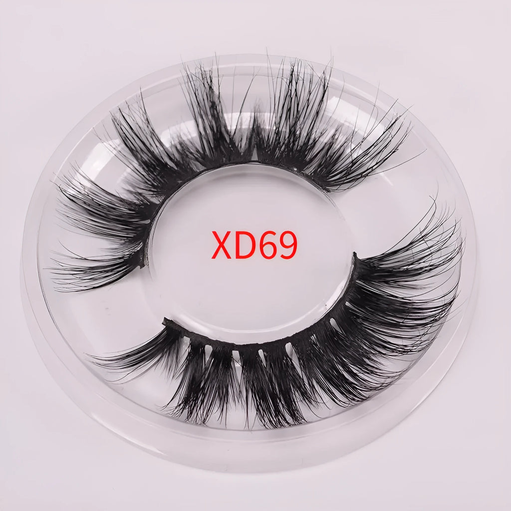 5D mink hair false eyelashes set with brush and storage cap on pink background.