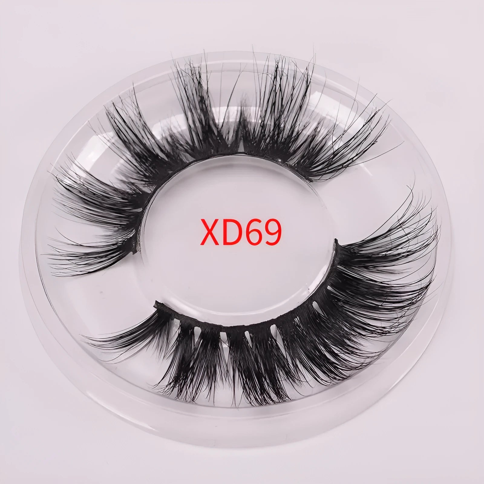 5D mink hair false eyelashes set with brush and storage cap on pink background.