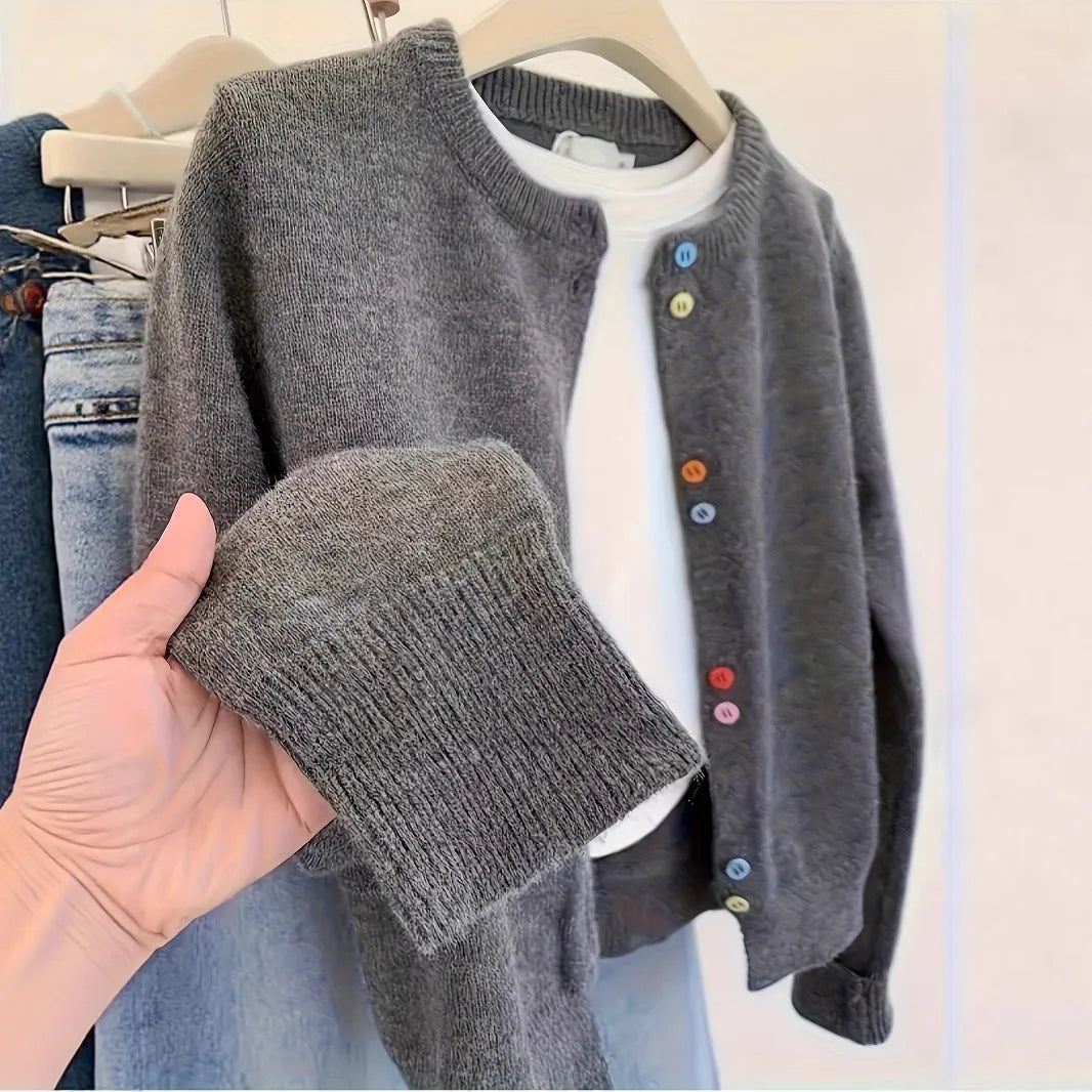 Dark grey solid colour women's polyester cardigan sweater with button front and long sleeves.