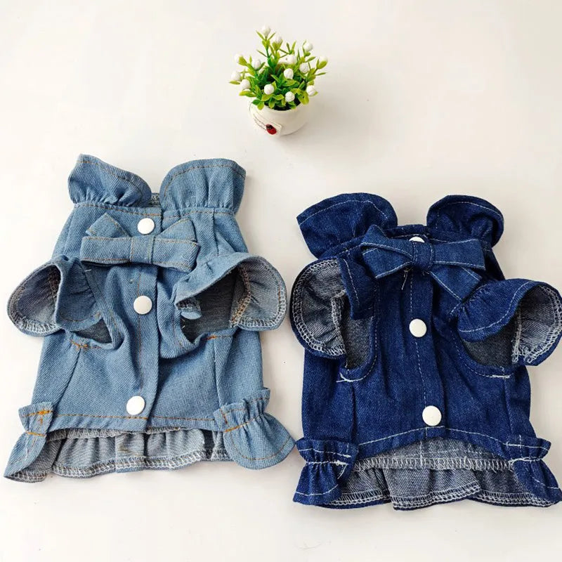 Blue denim dog dress with chest ruffles and a leash hook on the back, shown in dark blue and light blue.