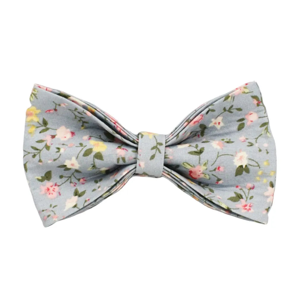 Blue floral patterned cloth dog collar and leash set with matching vest and bow accessories.