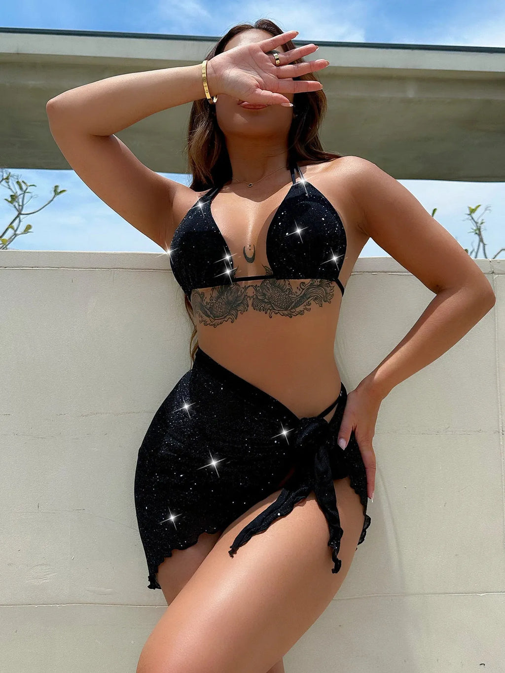 Black three-piece polyester bikini swimsuit set showing top and shorts.