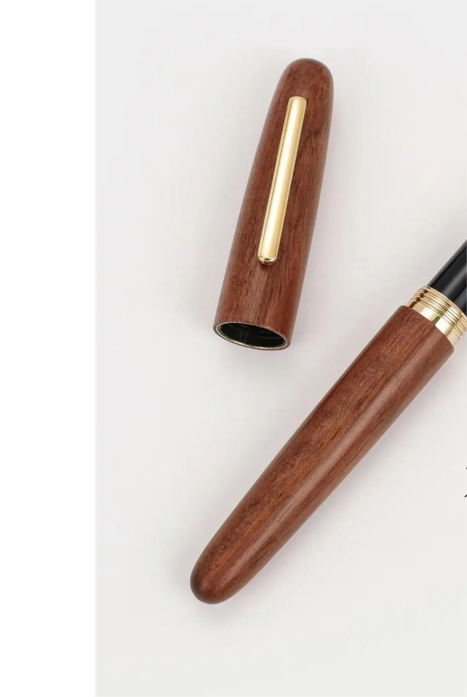 Wooden fountain pen with rotating cap shown in various wood finishes including rosewood and ebony.