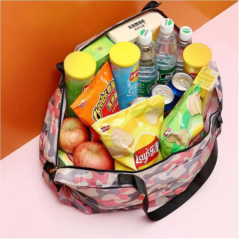 Foldable large-capacity shopping bag in 210d Oxford cloth with pink camouflage colour, hanging on a wall hook