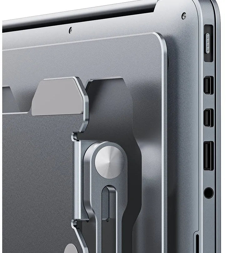 Grey aluminum folding laptop stand shown at an adjustable angle holding a silver laptop.