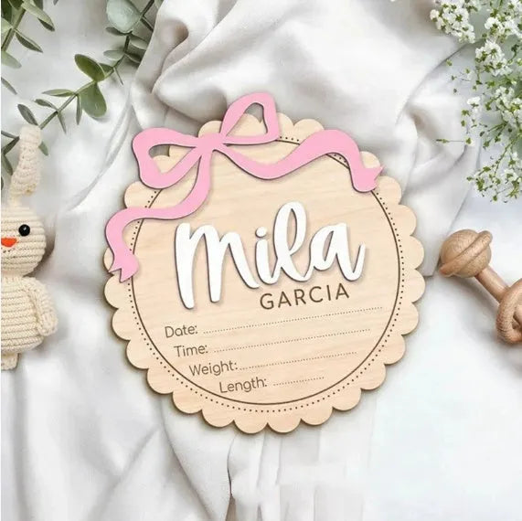 Customised square wooden baby room ornament with a personal name, shown in two size options.