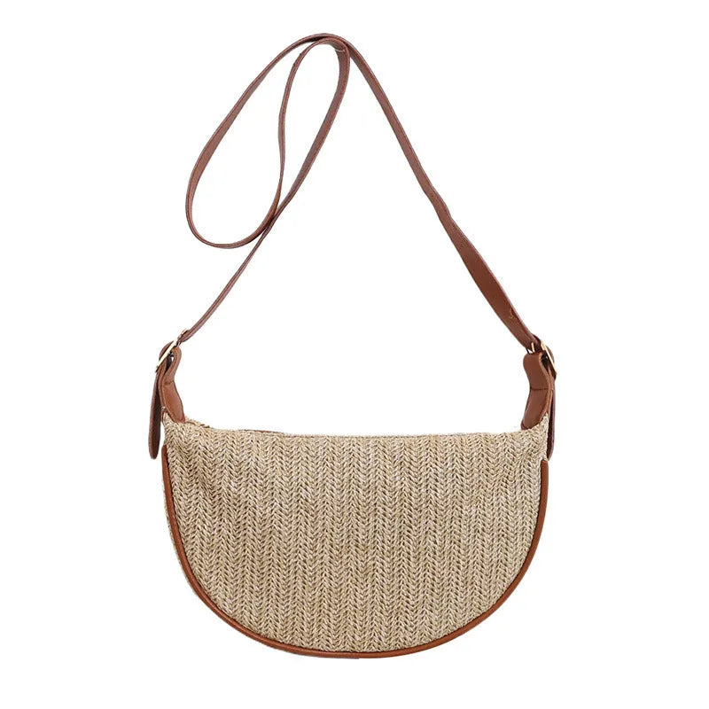Women's knitted straw woven crossbody bag showing woven texture and internal phone compartment