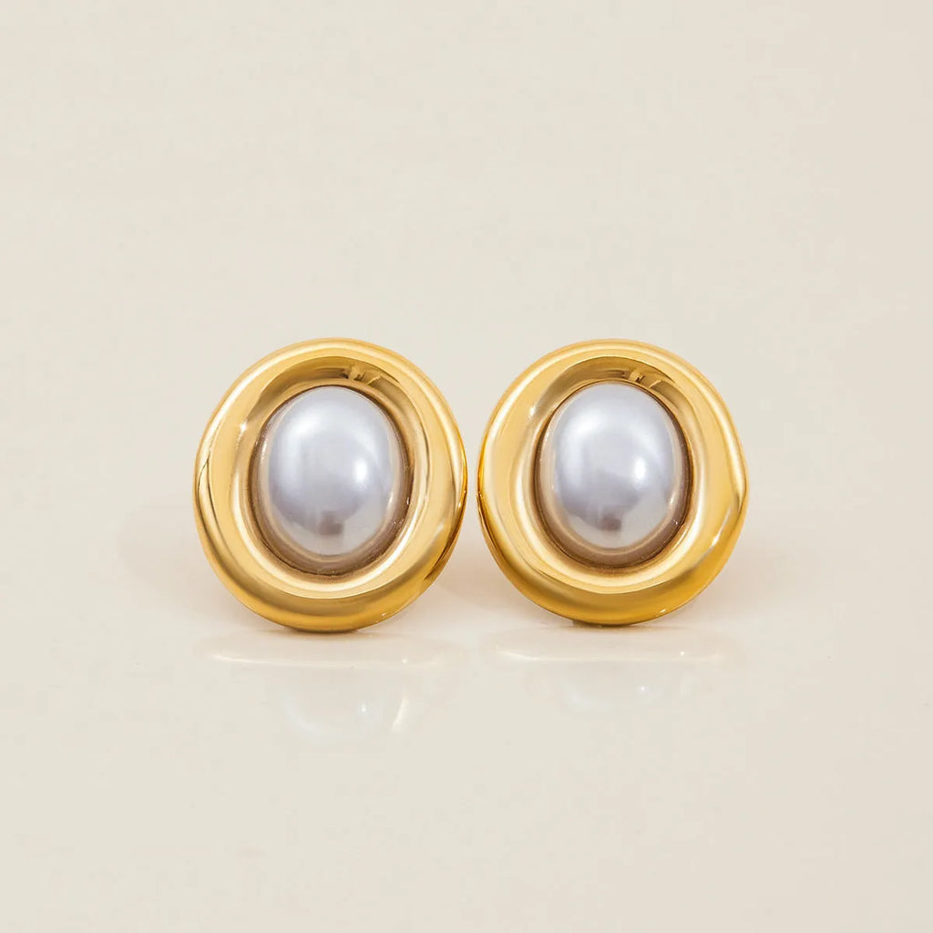 Close-up of women's stainless steel vintage pearl stud earrings with a silver-toned electroplated finish.