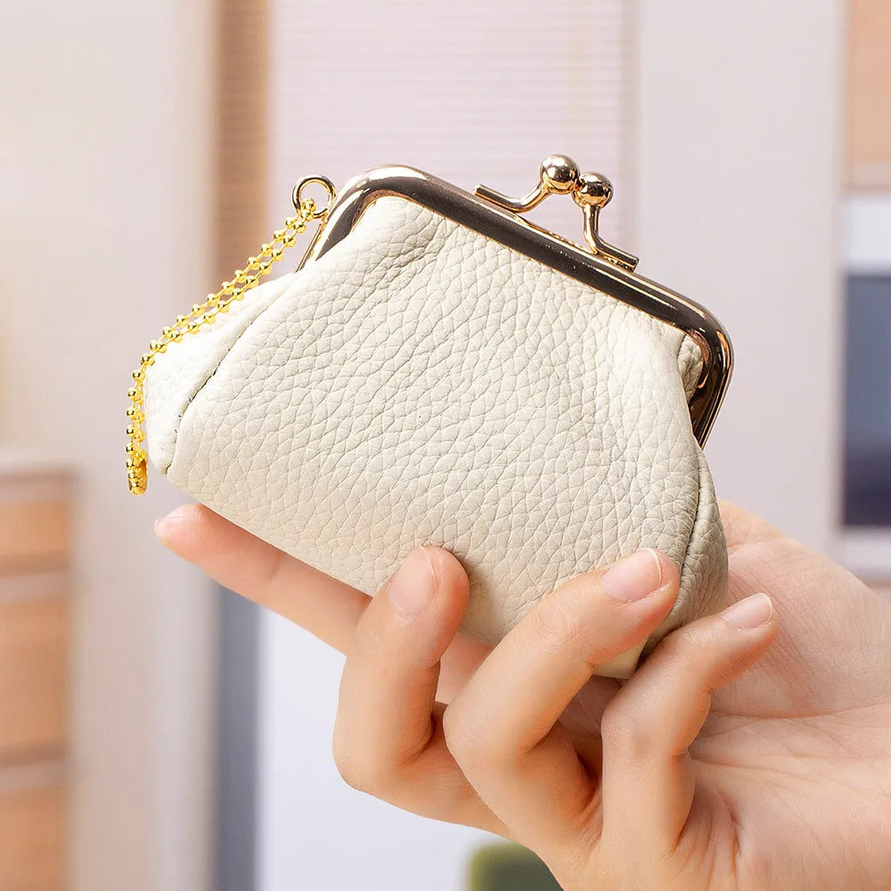 Genuine leather mini coin wallet in solid colour with visible sewing thread detail, first layer cowhide construction