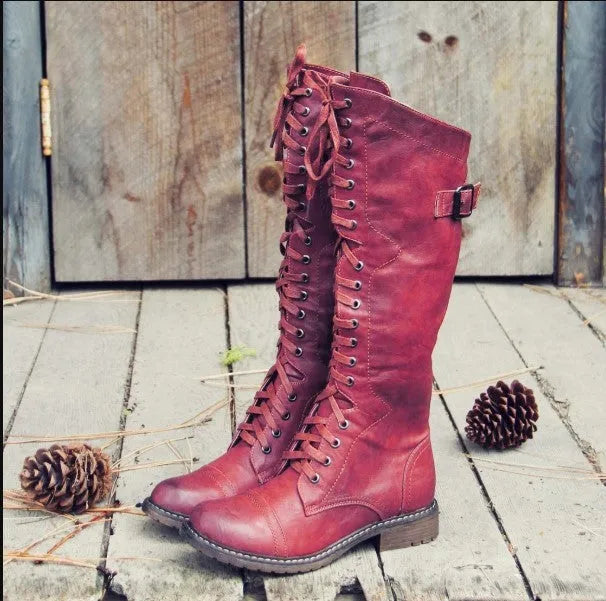 Women's black knight ankle boots with a cross-strap design, made from artificial PU leather.
