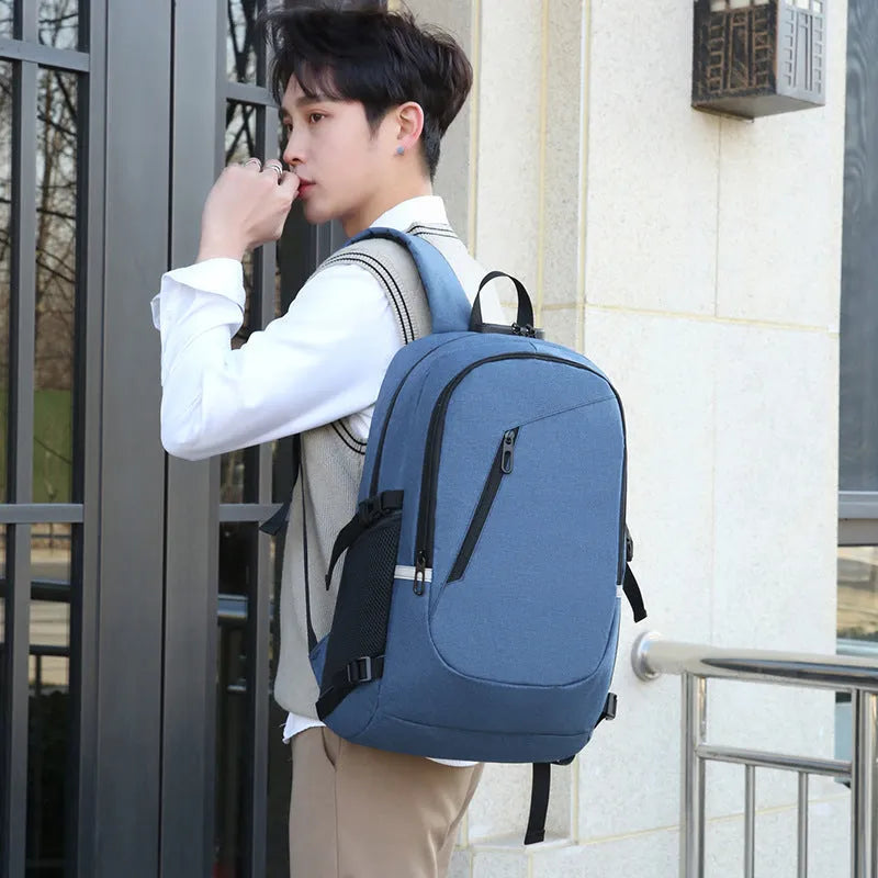 Blue Oxford cloth computer backpack with front pocket, shown next to grey and black colour options.