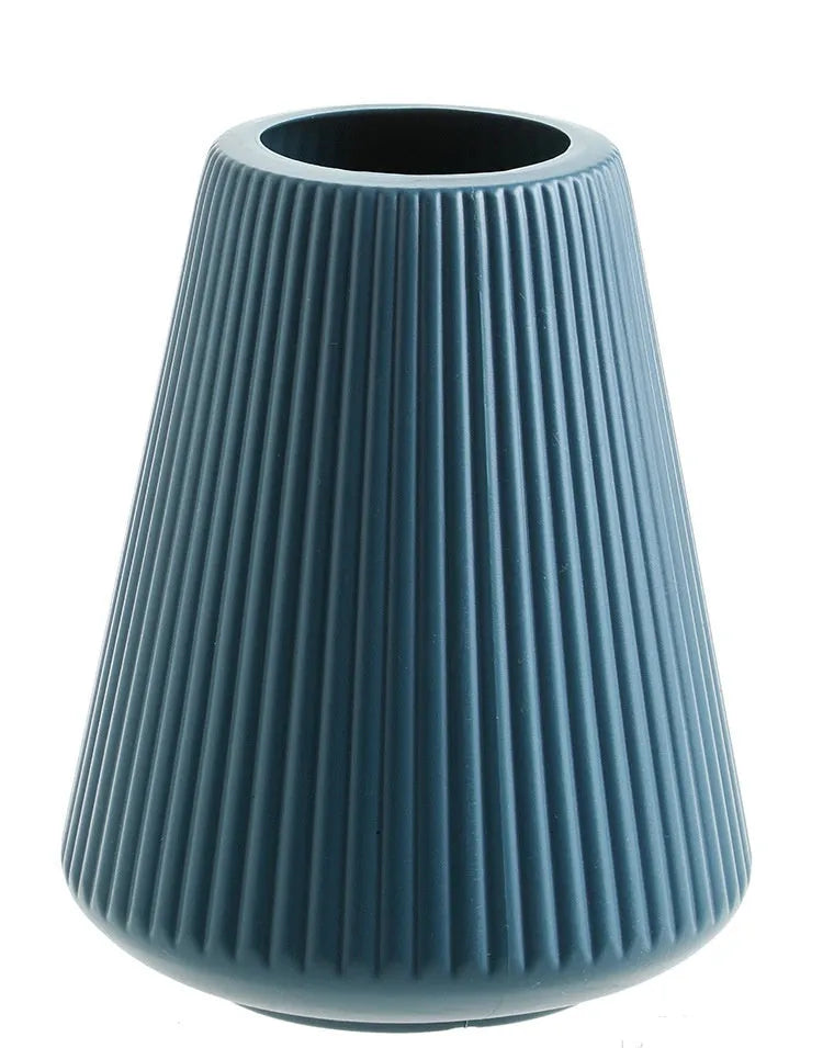 White melamine plastic decorative flower vase measuring 16cm by 20cm on a desktop