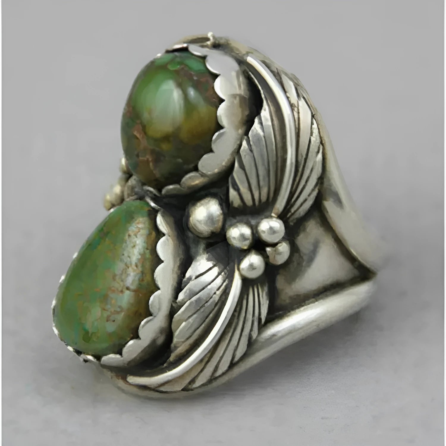 Geometric turquoise-coloured alloy ring for women on a grey background.