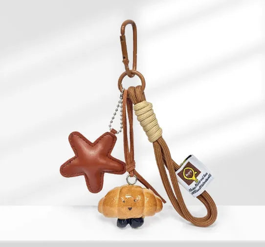 Handmade soda bread handbag pendant ornament with brown carrying strap on a bag.