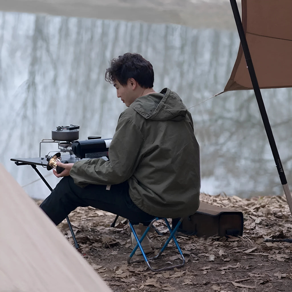 Black aluminium alloy folding camping stool in train-style design for outdoor use