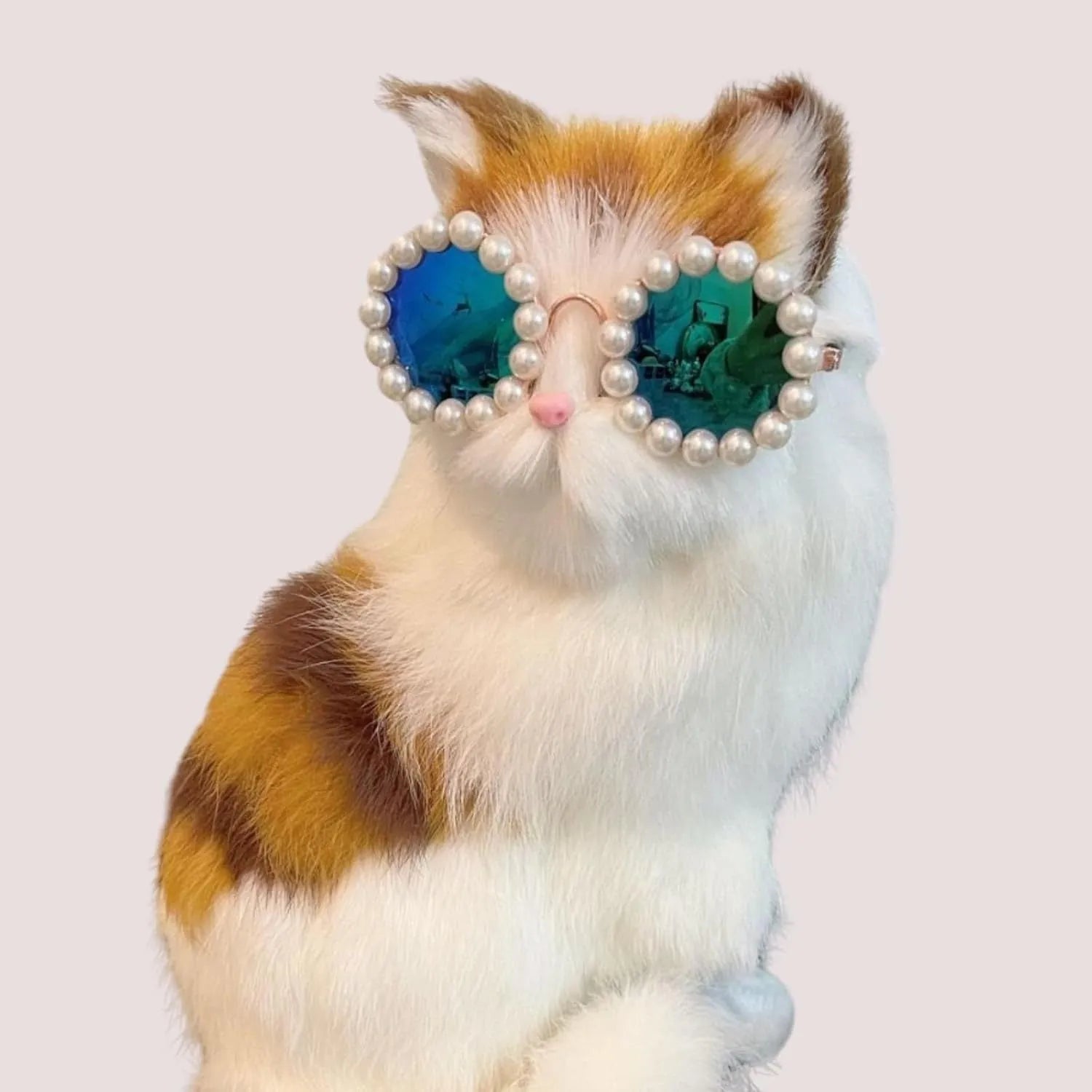 Pearl-rimmed round sunglasses for cats and dogs in multiple colours on a pink background.