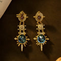 A pair of gold-coloured retro geometric stud earrings with a round shape and diamond-treated alloy surface.