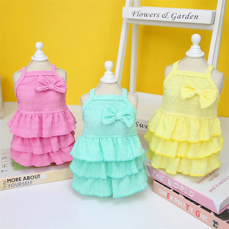 Small dog wearing polyester princess dress with candy layered skirt in water green colour