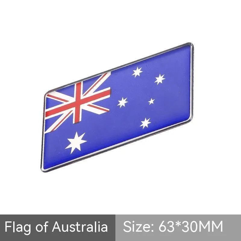 Aluminium parallelogram car sticker showing a national flag design, measuring 6.3 by 3 centimetres.