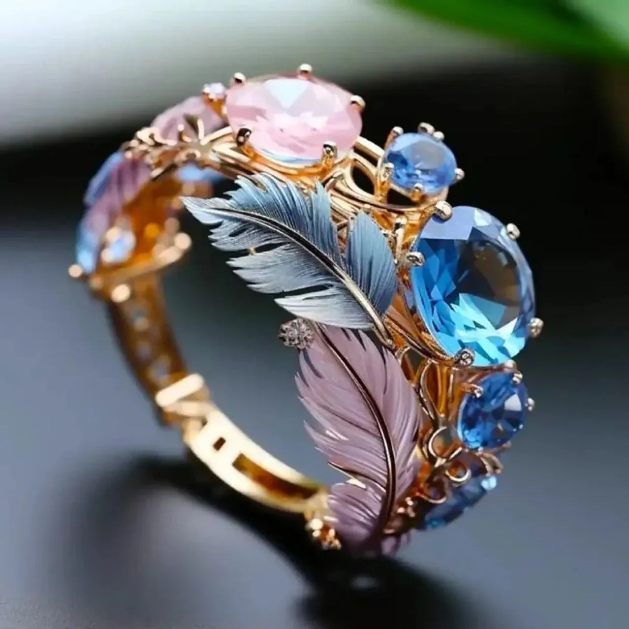 Gold colour brass feather ring with geometric design and zircon inlay, shown in embossed texture