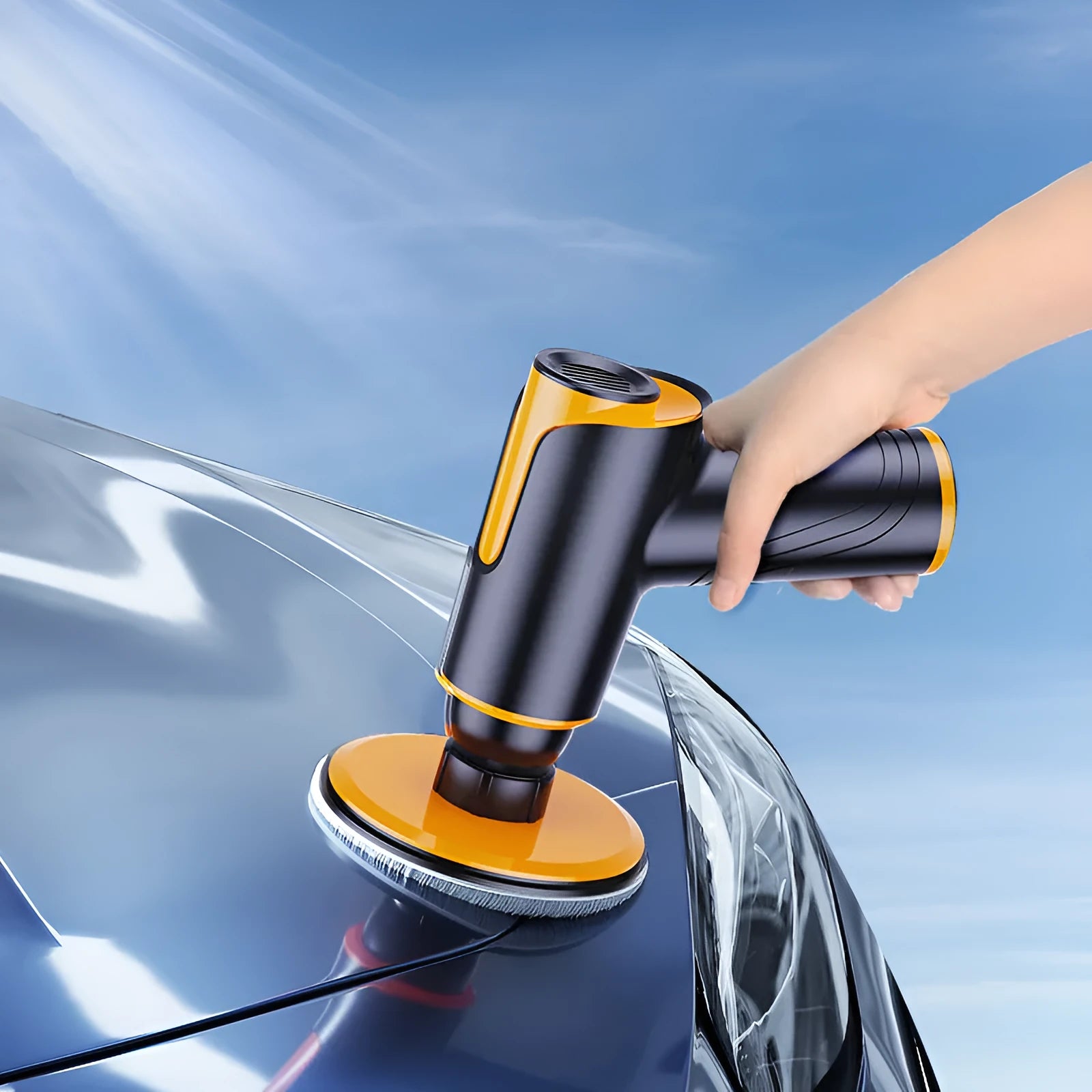 Black car polishing machine with 12cm disc and USB charging cable on a workshop bench