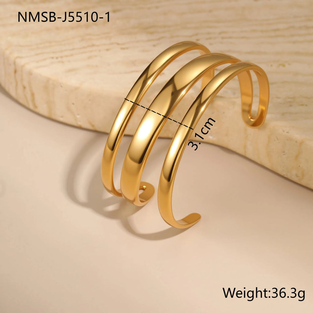 Gold and steel colour geometric line design stainless steel bracelet for women with simple opening clasp.