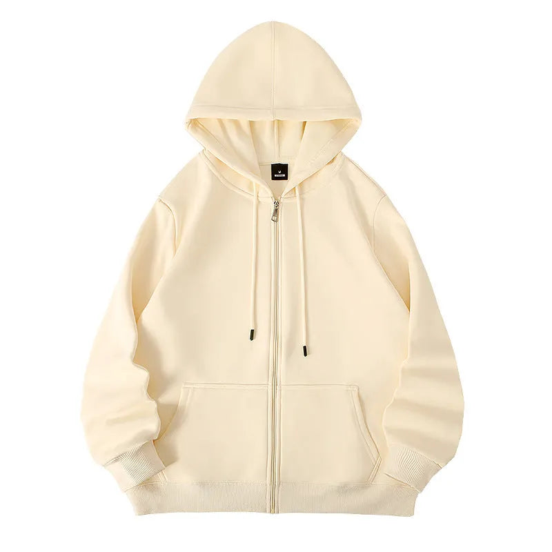 Man wearing a beige heavyweight cotton zip-up hooded cardigan with top-stitched pockets.