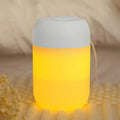 White cylindrical USB-powered mini humidifier with aromatherapy function on a desk.