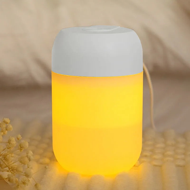 White cylindrical USB-powered mini humidifier with aromatherapy function on a desk.