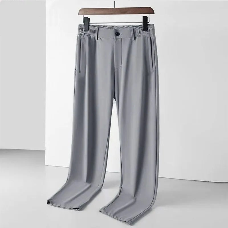 Man wearing black loose-fit ice silk straight leg casual trousers.